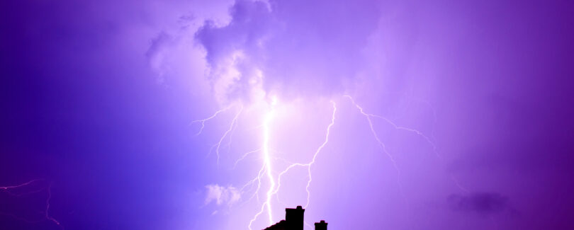 Dramatic sky and storm. Lightning hit the house. Power of nature concept.